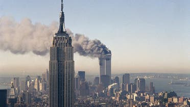 In this Sept. 11, 2001 file photo the twin towers of the World Trade Center burn behind the Empire State Building in New York after terrorists crashed two planes into the towers causing both to collapse (File Photo: AP/Marty Lederhandler)