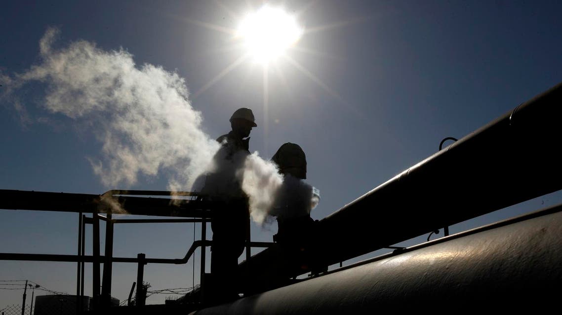 In this Feb. 26, 2011 file photo, a Libyan oil worker, works at a refinery inside the Brega oil complex, in Brega, eastern Libya. The official Libyan news agency said Sunday, April 6, 2014 that the country's main militia in the east has agreed to hand back control of four oil terminals it captured and shut down last summer in its demand for a share in oil revenues. The shutdown has cost Libya millions of dollars. (AP Photo/Hussein Malla, File)