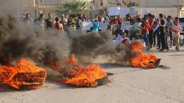 People gather near burning tyres during a demonstration against forces loyal to Syria's president Bashar al-Assad and calling for aid to reach Aleppo near Castello road in Aleppo. (Reuters)
