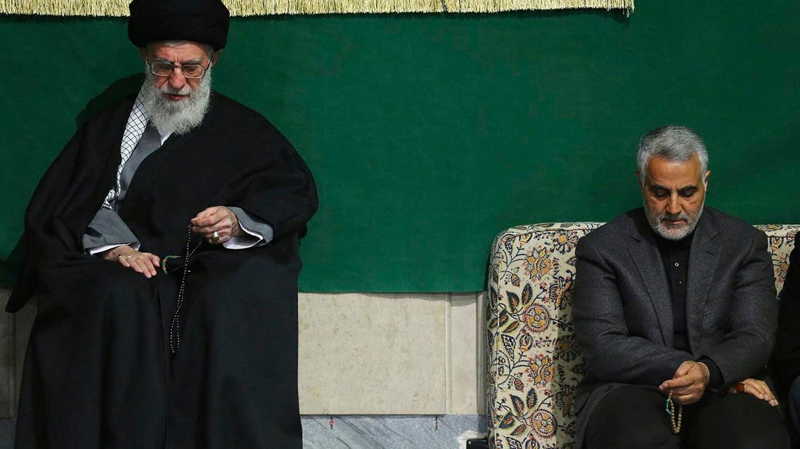 In Friday, March 27, 2015 file this photo released by an official website of the office of the Iranian supreme leader, commander of Iran's Quds Force, Qassem Soleimani, right, sits next to the Supreme Leader Ayatollah Ali Khamenei while attending a religious ceremony in a mosque at his residence in Tehran, Iran. The tide of global rage against the Islamic State group lends greater urgency to ending the jihadis’ ability to operate at will from a base in war-torn Syria. Iran has sent more advisers into Syria in recent weeks, as well as reportedly dispatching again Gen. Qassem Soleimani. (AP Photo/Office of the Iranian Supreme Leader, File)