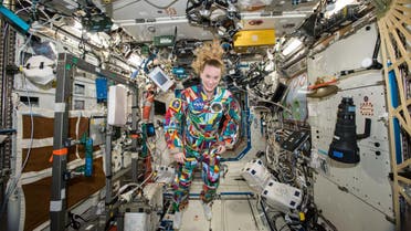  NASA  astronaut Kate Rubins aboard the International Space Station wearing a hand-painted spacesuit decorated by childhood cancer patients at the University of Texas MD Anderson Cancer Center in Houston. NASA said Rubins will chat from the space station with patients during a 20-minute call on Friday, Sept. 16, 2016. (NASA via AP)