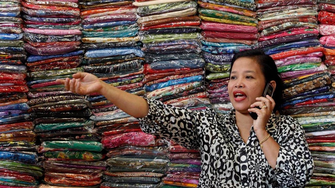 Fadhilah Arshad, a businesswoman, talks to a supplier as she sells cloth at her bazaar in Kuala Lumpur December 1, 2009. (Reuters)