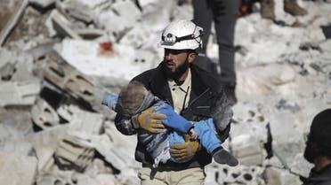 A civil defence member carries a dead child in a site hit by what activists said were airstrikes carried out by the Russian air force in the rebel-controlled area of Maaret al-Numan town in Idlib province, Syria. REUTERS