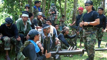Undated file photo of Abu Sayyaf spokesman Abu Sabaya (right foreground), with militants in Basilan, the Philippines. Abu Sayyaf, a group in the southern Philippines that professes radical ideology but which is better known for banditry and kidnappings, has declared allegiance to ISIS.