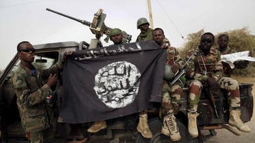 Nigerian soldiers hold up a Boko Haram flag that they had seized. (File Photo: Reuters)