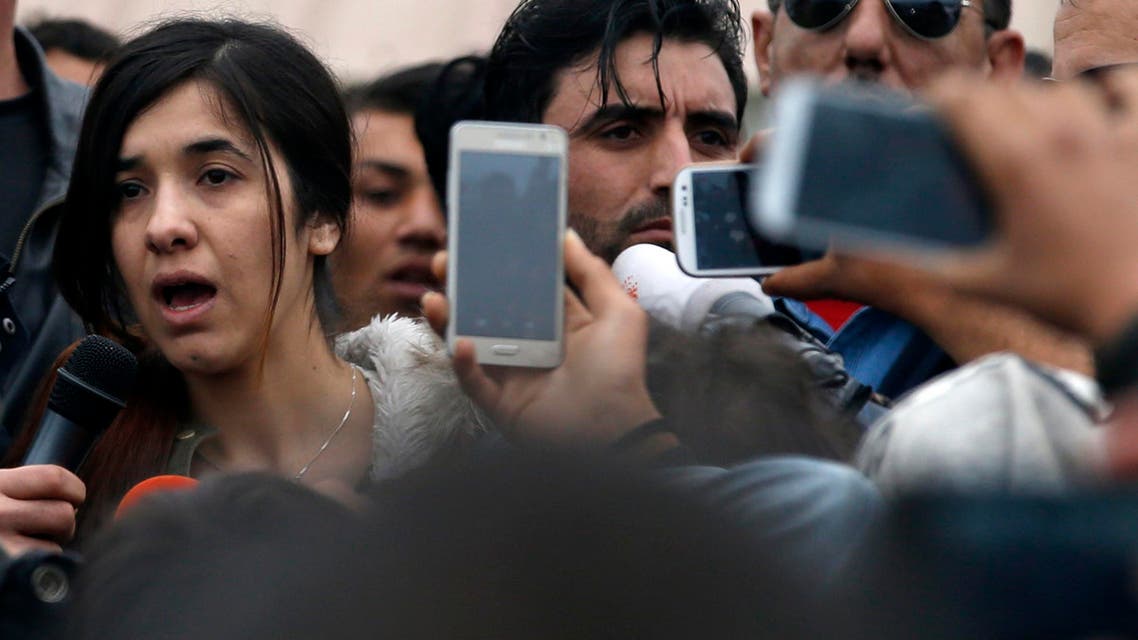 An Islamic State victim Iraqi Yazidi Nadia Murad Basee Taha, left, speaks during her visit in the makeshift refugee camp at the northern Greek border point of Idomeni, Greece, Sunday, April 3, 2016. (AP)