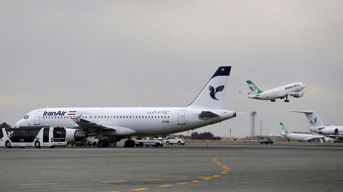 In this Feb. 7, 2016 file photo, an Iranian Mahan Air passenger plane takes off as a plane of Iran's national air carrier, Iran Air, is parked at left, at Mehrabad airport in Tehran, Iran. Boeing Co. said Tuesday it signed an agreement with Iran Air "expressing the airline's intent" to buy its aircraft, setting up the biggest business deal between the Islamic Republic and America since the 1979 U.S. Embassy takeover in Tehran. Boeing Co.’s historic deal with Iran Air rests on shaky foundations, with potentially $25 billion riding on hopes that Tehran would stop its past practice of using the airline’s planes to ferry fighters and weapons across the Middle East.(AP Photo/Vahid Salemi, File)