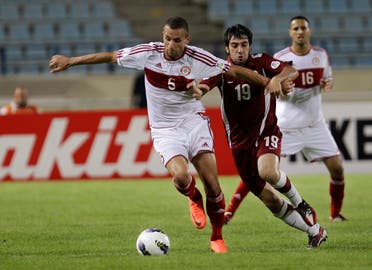  Lebanon's Ramez Dayoub, left, who accused of match-fixing, fights for the ball against Qatar's Khaled Muftah, right, during their 2014 World Cup Asian Qualifying soccer match, in Beirut, Lebanon. AP
