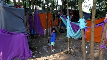 A refugee child brushes her teeth on the Hungary-Serbia border, in a camp outside a transit zone set up by Hungarian authorities to filter refugees at Roszke, Hungary, September 2, 2016. Picture taken September 2, 2016. reuters