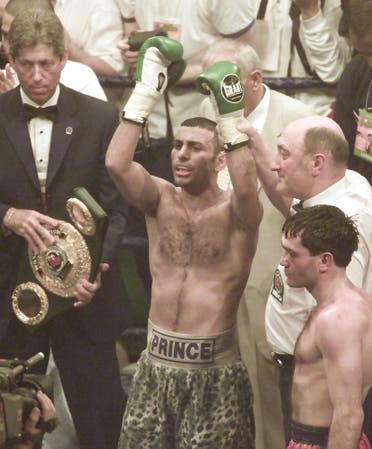 Prince Naseem Hamed of Britain, center, with arms raised get the points decision against Manuel Calvo from Spain for the IBO Featherweight Championship of the World at the London Arena in London in 2002. (AP)