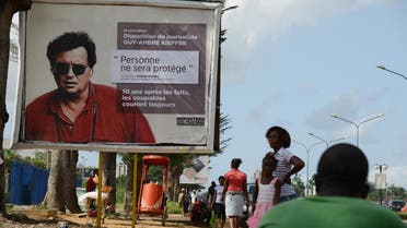 French-Canadian journalist Guy-Andre Kieffer pictured on the billboard was last seen in a car park in Abidjan in April 2004 with Michel Legre (AFP)