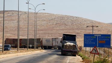 Commercial Turkish trucks wait to cross to Syria near the Cilvegozu border gate, located opposite the Syrian commercial crossing point Bab al-Hawa in Reyhanli, Hatay province, Turkey, September 16, 2016. REUTERS/Osman Orsal