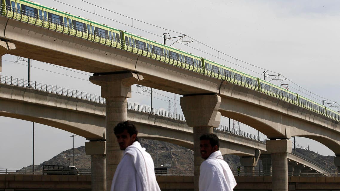 A Mecca Metro train passes over Muslim pilgrims' heads towards Mina ahead of the hajj main ritual at Mount Arafat outside Mecca, Saudi Arabia. AP