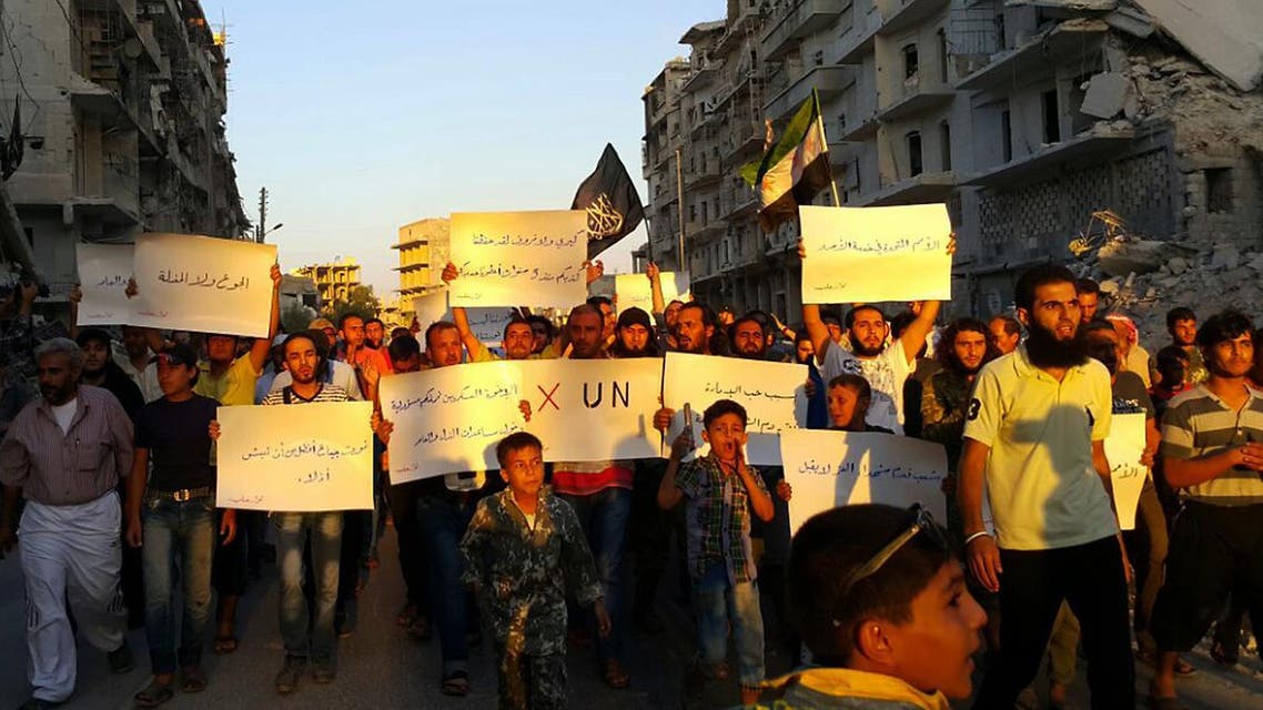 In this Tuesday, Sept. 13, 2016, file photo, activists in Syria’s besieged Aleppo protest against the United Nations for what they say is its failure to lift the siege off their rebel-held area. (AP)