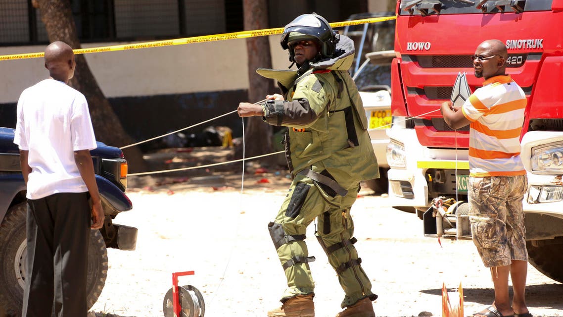 One of the bodies of three women who were shot dead by police lies outside the central police station in the coastal city of Mombasa, Kenya Sunday, Sept. 11, 2016.