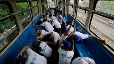 Employees duck and cover their heads as they participate in a Metro-wide earthquake drill on the Light Railway Transit, LRT, station in Manila, Philippines on Wednesday, June 22, 2016. Government agencies, schools and private companies participated in a massive drill across Manila designed to boost preparedness in the country. (AP)