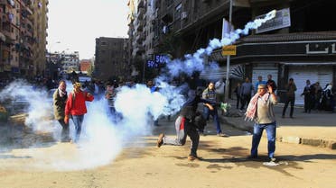 A supporter of Egypt’s ousted President Mohammed Morsi throws tear gas towards Egyptian security forces in Cairo, Egypt, Friday, Dec. 27, 2013 (File Photo: AP/El Shorouk newspaper, Ahmed Abd El Latif) 