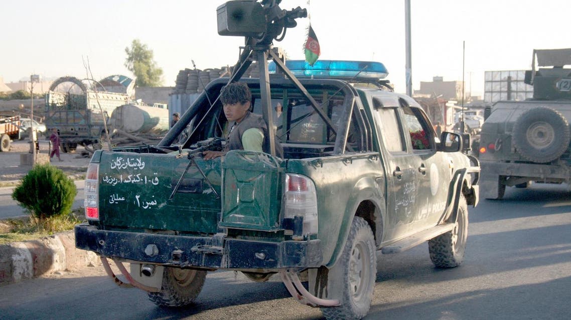 An Afghan policeman travels in the back of a truck in Tirin Kot, the capital of Uruzgan province southern of Kabul, Afghanistan, Thursday, Sept. 8, 2016. The Taliban pushed into the capital of Afghanistan's southern Uruzgan province on Thursday, triggering fierce clashes and sending all government officials fleeing from the city, an Afghan official said. (AP Photo)