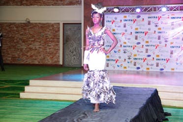 A Ugandan models a dress on the runway at the third annual Uganda Network of Young People Living with HIV beauty pageant at Golf Course Hotel Kampala, Uganda, Saturday Sept. 24, 2016. 