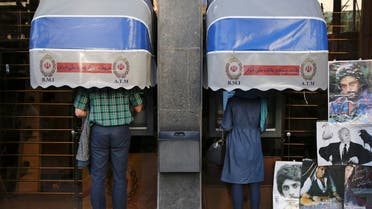 Iranians use ATM machines of Bank Melli Iran in downtown Tehran, Iran. AP