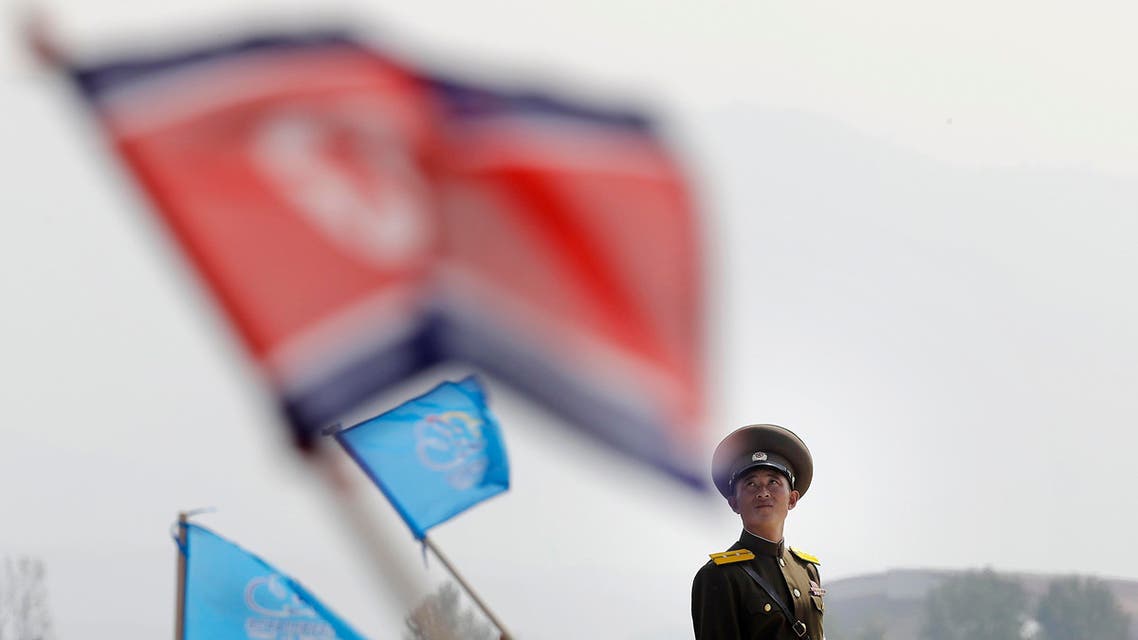 In this Sept. 24, 2016 file photo, a North Korean military soldier stands guard as North Koreans wave flags and cheer during an aerial display, in Wonsan, North Korea. North Korea on Saturday opened an air festival featuring sky diving, demonstrations by its air force and lots of beer to promote a newly renovated and upgraded commercial airport in the coastal city of Wonsan that it hopes will draw for foreign tourists. (AP Photo/Wong Maye-E, File)