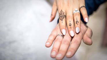 Illustrative image shows the hands of a bride and a groom wearing rings. (Shutterstock) 
