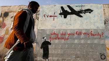 A man walks past a graffiti, denouncing strikes by US drones in Yemen, painted on a wall in Sanaa, Yemen on November 13, 2014. (File photo: Reuters)