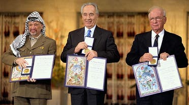 Yitzhak Rabin, Shimon Peres, and Yasser Arafat take a picture the day they receive the 1994 Nobel Peace Prize. (AP)