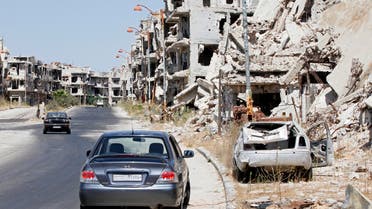 Damaged buildings and rubble line a street in Homs, Syria, Sept. 19, 2016. (ap)