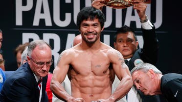 In this April 8, 2016, file photo, Manny Pacquiao, of the Philippines, poses on the scale during a weigh-in in Las Vegas. AP
