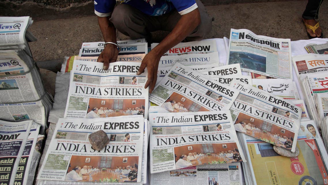 A newspaper vendor arranges morning newspapers carrying headlines of India's military strikes, in Jammu, India, Friday, Sept. 30, 2016. (AP)
