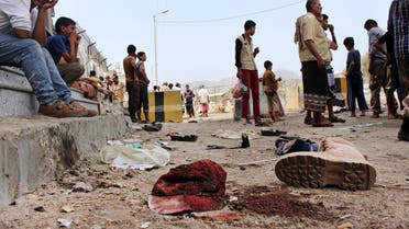 People gather at the scene after a pair of suicide bombings attack in the southern city of Aden, Yemen, Monday, May 23, 2016. (AP)