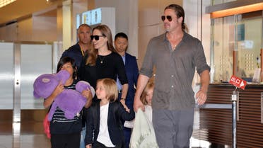 US film stars Brad Pitt (R) and Angelina Jolie (C), accompanied by their children, arrive at Haneda International Airport in Tokyo on July 28, 2013. Pitt is now here for the promotion of his latest movie "World War Z". AFP PHOTO / Yoshikazu TSUNO YOSHIKAZU TSUNO / AFP