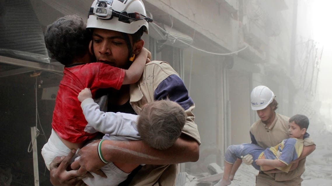 Members of the Civil Defence rescue children after what activists said was an air strike by forces loyal to Syria's President Bashar al-Assad in al-Shaar neighbourhood of Aleppo, Syria June 2, 2014. REUTERS
