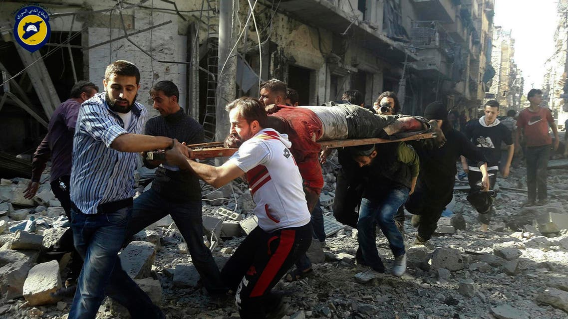 In this photo provided by the Syrian Civil Defense group known as the White Helmets, Syrians carry a victim after airstrikes by government helicopters on the rebel-held Aleppo neighborhood of Mashhad, Syria, Tuesday Sept. 27, 2016. (AP)