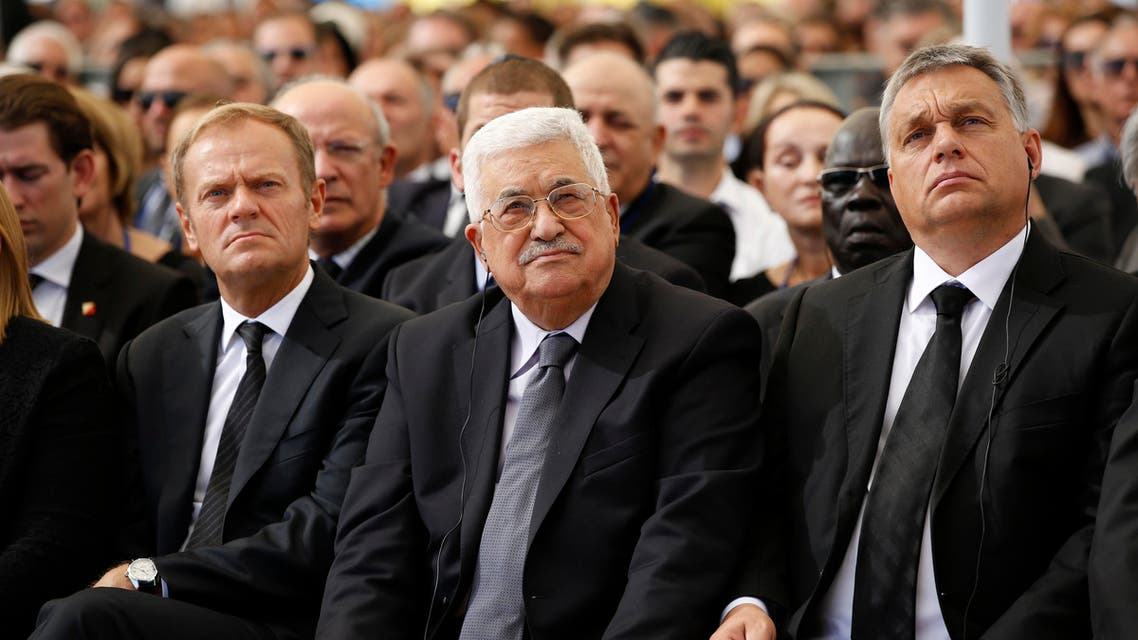 Palestinian President Mahmoud Abbas, center, sits next to European Council President Donald Tusk, left, during the funeral of former Israeli President Shimon Peres at Mt. Herzl Military Cemetery in Jerusalem, Friday, Sept. 30, 2016. (Abir Sultan/Pool Photo via AP)