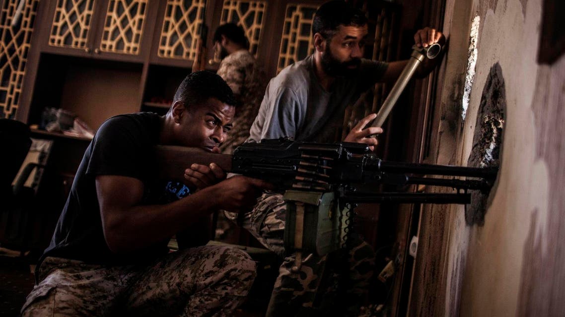 Libyan forces fighter affiliated with the Tripoli government searches for sniper positions from a hole in a building on the frontline in Sirte, Libya (File Photo: AP /Manu Brabo)
