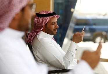 Saudi men explore social media on their mobile devices as they sit at a cafe in Riyadh, Saudi Arabia May 24, 2016. REUTERS/Faisal Al Nasser