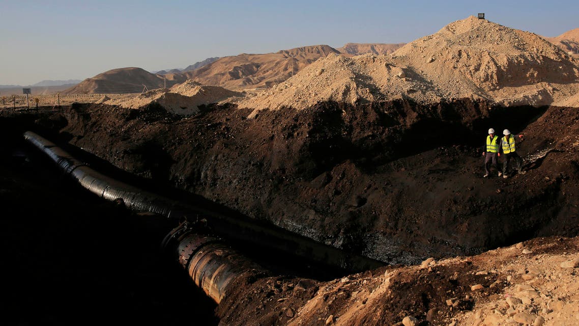 File photoof the Trans-Israel Pipeline clean up the large deposits of crude oil that gushed out of a breached pipeline near the village of Beer Ora, north of Eilat. AP