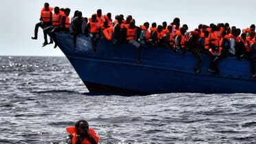 Migrants wait to be rescued as they drift in the Mediterranean Sea some 20 nautical miles north off the coast of Libya on October 3, 2016. Italy coordinated the rescue of more than 5,600 migrants off Libya, three years to the day after 366 people died in a sinking that first alerted the world to the Mediterranean migrant crisis. (AFP)