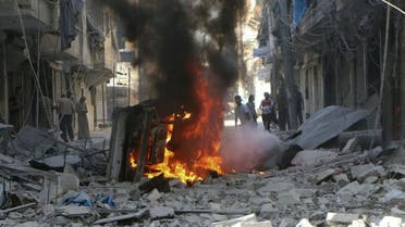 In this photo provided by the Syrian Civil Defense group known as the White Helmets, Syrians inspect damaged buildings after airstrikes by government helicopters on the rebel-held Aleppo neighborhood of Mashhad, Syria, Tuesday Sept. 27, 2016. AP