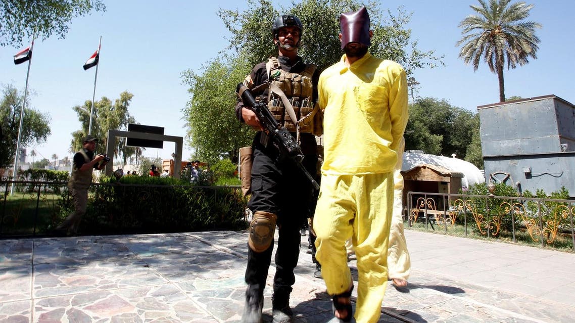 Men, who according to the Iraqi security forces are suspected ISIS militants, walk in a line during a presentation to the media at Iraqi military intelligence directorate in Baghdad. (Reuters)