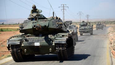 Turkish troops drive their tanks on September 4, 2016 on a road near the Syrian village of al-Waqf and some 3km south of al-Rai, the small border town with Turkey. (AFP)