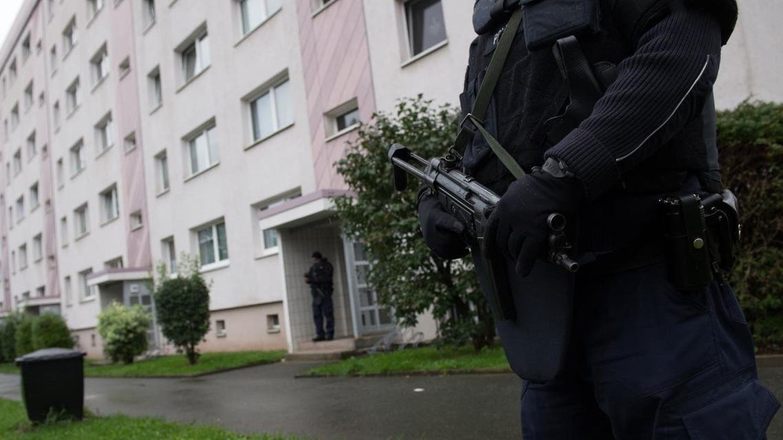 Police officers secure a residential area in Chemnitz, eastern Germany, Saturday Oct. 8,2016. German police have raided an apartment building in the eastern city of Chemnitz after receiving information someone may be planning a bombing attack. (Arno Burgi/dpa via AP)