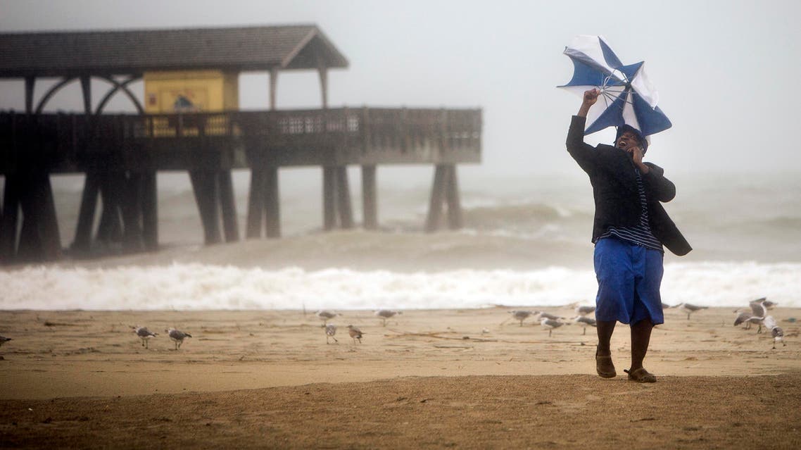 Preston Payne tires to hold his umbrella as he watches the waves near the Tybee pier as Hurricane Matthew makes its way up the East Coast, Friday, Oct. 7, 2016, on Tybee Island, Ga. Authorities warned that the danger was far from over, with hundreds of miles of coastline in Florida, Georgia and South Carolina still under threat of torrential rain and dangerous storm surge as the most powerful hurricane to menace the Atlantic Seaboard in over a decade pushed north. (AP)