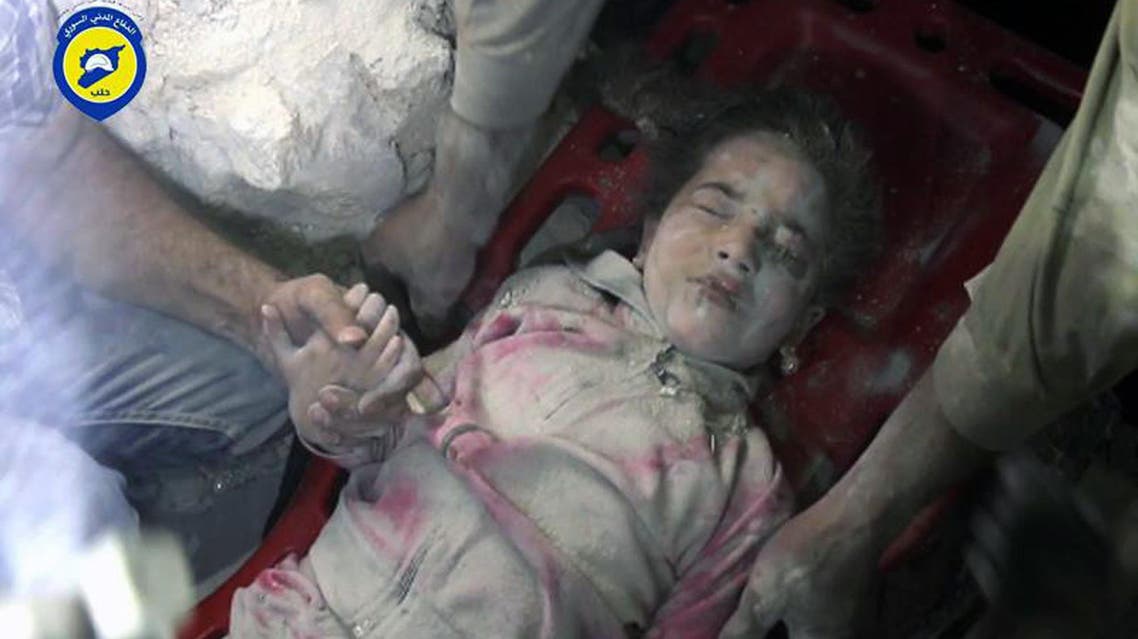 In this Wednesday, Sept. 28, 2016, photo provided by the Syrian Civil Defense group known as the White Helmets, shows survived child Ghazal Akhtarini, carried by Civil Defense workers from under the rubles after airstrikes hit al-Shaar neighborhood in Aleppo, Syria. AP
