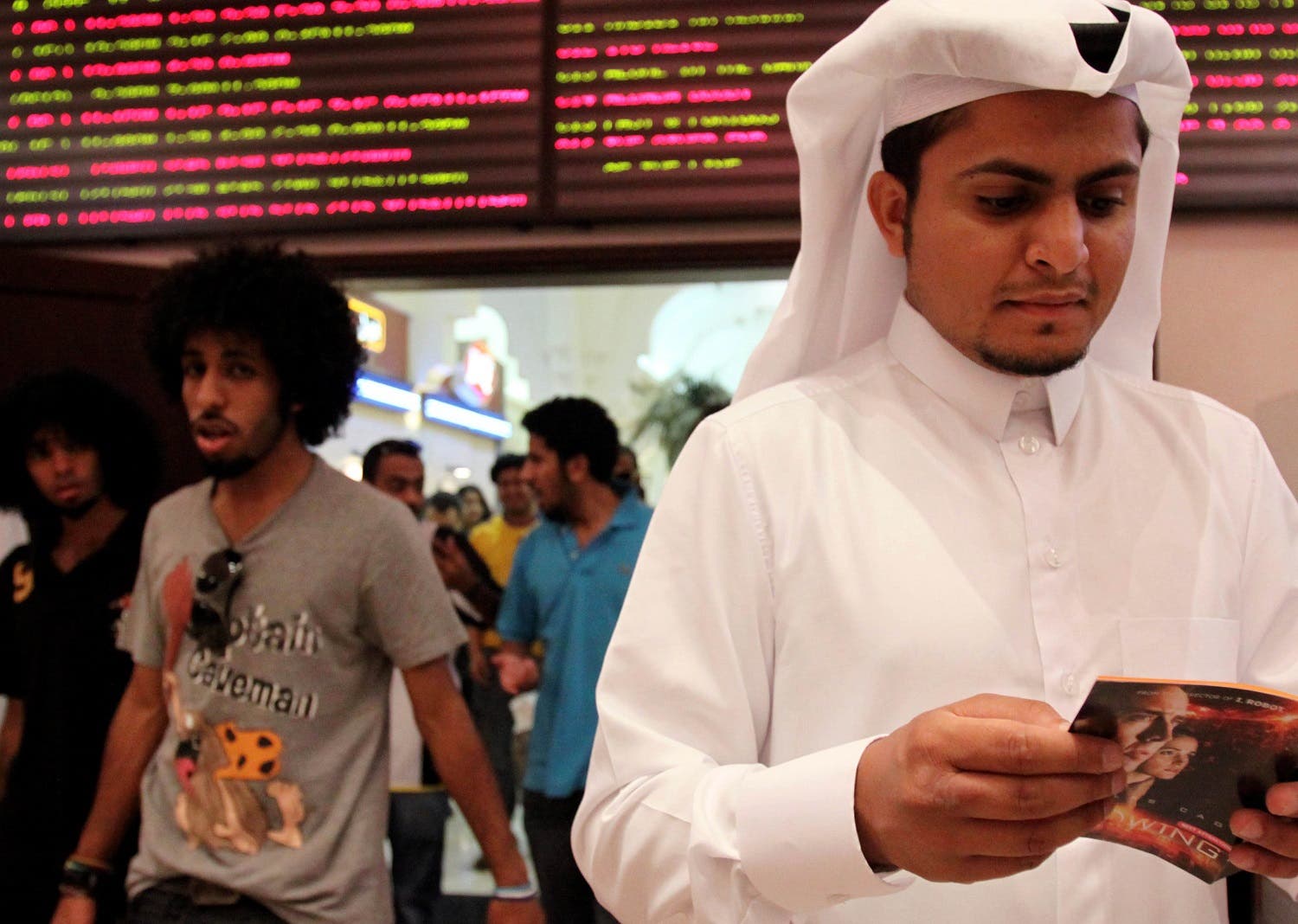 In this photo taken on May 7, 2009, Walid al-Musharraf, 27, of Riyadh, Saudi Arabia, looks at a brochure outside a Manama, Bahrain, movie theater. (File photo: AP)