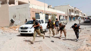 Fighters from Libyan forces allied with the U.N.-backed government run for cover during a battle with Islamic State militants in their remaining holdouts, in neighbourhood Number Three in Sirte, Libya, October 8, 2016. reuters