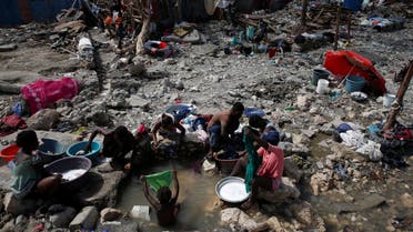 People wash their clothes on a beach near destroyed houses after Hurricane Matthew hit Jeremie, Haiti, October 10, 2016. (Reuters)