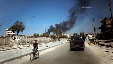 In this Sunday, Sept. 23, 2012 file photo, black smoke leaps the air from government shelling in a residential area in Aleppo, Syria. ap